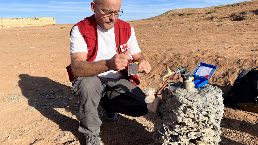 IFRC water, sanitation and hygiene delegate Gregory Gonzalez tests the quality of a newly installed water point in a remote Moroccan village following the September 2023 earthquake.