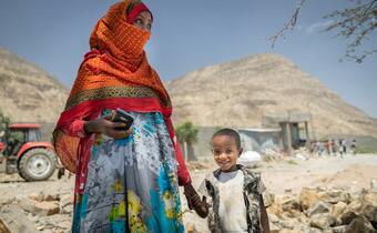 An Ethiopian woman and her child stand in Abala district on the eastern border of Tigray in March 2021 where thousands of people have been internally displaced due to fighting