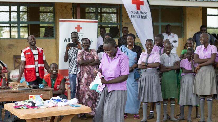 Talking about menstruation can be embarassing because of cultural taboos and sometimes, humor and laughter can help people break through their discomfort. Here, a female student laughs along with classmates as she takes part in the demonstration. 