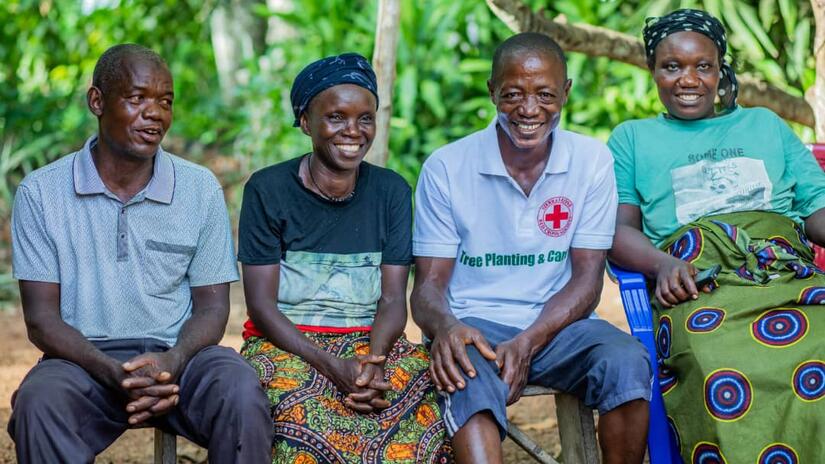 Four participants in the Sierra Leone Red Cross’s Tree Planting and Care initiative share a moment of satisfaction after work. One key objective for the women who take the lead in the project is to mobilize community members to ensure the ongoing care of the trees until they reach maturity.  